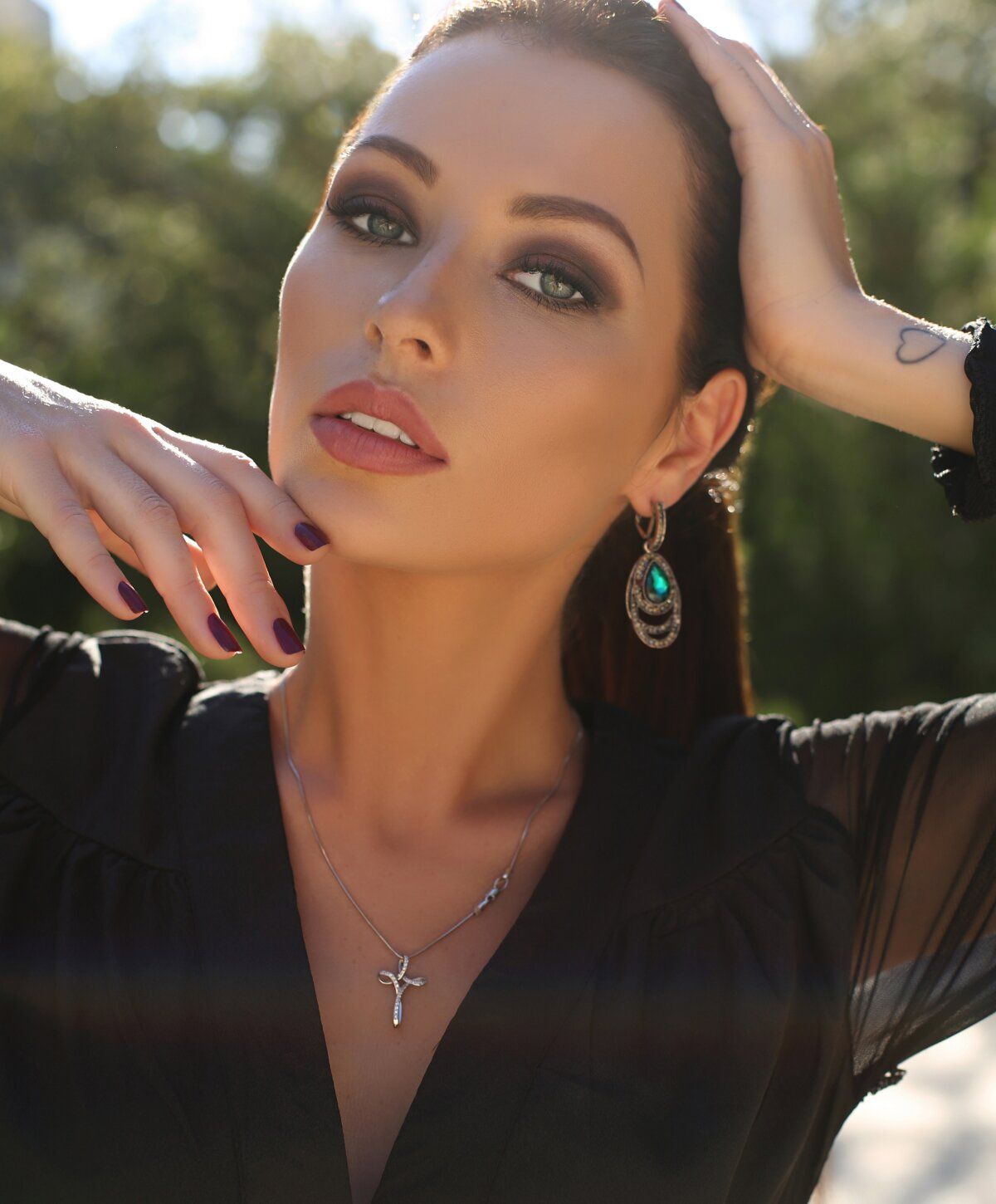 Woman with elegant accessories and striking makeup.