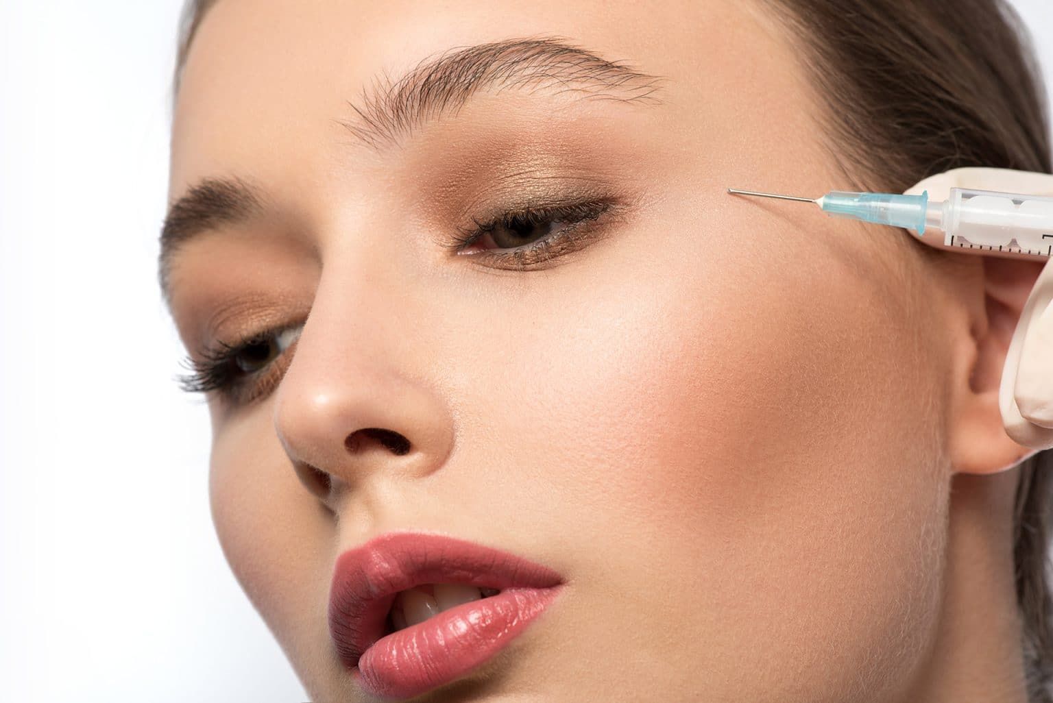 Close-up of woman receiving cosmetic injection treatment.
